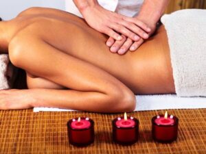 hands of massage therapist on a clients' body.